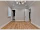 Bright bedroom showcases hardwood floors, modern lighting, and entry doors with white trim at 1169 Dorby Park Ne Dr, Brookhaven, GA 30319
