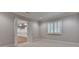 Bedroom with neutral carpeting, paneled walls, windows with white shutters and a doorway to another room at 1169 Dorby Park Ne Dr, Brookhaven, GA 30319