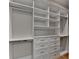 Spacious walk-in closet with custom built-in shelving and drawers for optimal storage at 1169 Dorby Park Ne Dr, Brookhaven, GA 30319