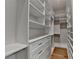 Walk-in closet with custom shelves, drawers, and hanging rods for ample storage at 1169 Dorby Park Ne Dr, Brookhaven, GA 30319