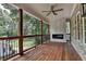 A wood floored deck with railings, a fireplace, and ceiling fan overlooking the backyard at 1169 Dorby Park Ne Dr, Brookhaven, GA 30319