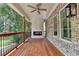 A wood floored deck featuring railings, a fireplace, and ceiling fan overlooking the backyard at 1169 Dorby Park Ne Dr, Brookhaven, GA 30319