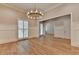 Dining room with wainscoting, chandelier, and gleaming wood floors at 1169 Dorby Park Ne Dr, Brookhaven, GA 30319