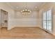 Charming dining room with wainscoting, chandelier, and wood floors at 1169 Dorby Park Ne Dr, Brookhaven, GA 30319