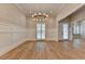 Dining room with wainscoting, chandelier, and gleaming wood floors at 1169 Dorby Park Ne Dr, Brookhaven, GA 30319