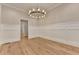 Dining room with wainscoting, chandelier, and gleaming wood floors at 1169 Dorby Park Ne Dr, Brookhaven, GA 30319