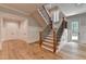 Entryway features hardwood floors, staircase with iron spindles, wainscotting, and view of the outdoors at 1169 Dorby Park Ne Dr, Brookhaven, GA 30319