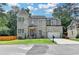 Beautiful two-story home with gray brick, manicured lawn and a two-car garage at 1169 Dorby Park Ne Dr, Brookhaven, GA 30319