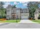 Beautiful two-story home with gray brick, manicured lawn and a two-car garage at 1169 Dorby Park Ne Dr, Brookhaven, GA 30319