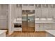 Kitchen area featuring stainless steel refrigerator, oven, white cabinets, and stone countertops at 1169 Dorby Park Ne Dr, Brookhaven, GA 30319
