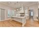 Modern kitchen featuring a large central island, stainless steel appliances, and white cabinetry at 1169 Dorby Park Ne Dr, Brookhaven, GA 30319