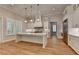 Modern kitchen featuring white cabinetry with gold hardware, a central island, and recessed lights at 1169 Dorby Park Ne Dr, Brookhaven, GA 30319