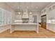 A kitchen featuring white cabinetry with gold hardware, a center island and stainless steel appliances at 1169 Dorby Park Ne Dr, Brookhaven, GA 30319