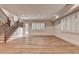 Bright living room with hardwood floors, paneled walls, stairs and a glass paned door at 1169 Dorby Park Ne Dr, Brookhaven, GA 30319