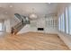 Open-concept living room with stairs, hardwood floors, custom built-ins, and natural light at 1169 Dorby Park Ne Dr, Brookhaven, GA 30319