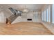Open-concept living room featuring hardwood floors, a fireplace, custom built-ins, and a staircase at 1169 Dorby Park Ne Dr, Brookhaven, GA 30319