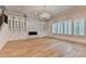 Spacious living room with hardwood floors, fireplace, custom built-ins, and large windows for natural light at 1169 Dorby Park Ne Dr, Brookhaven, GA 30319