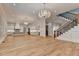 Hardwood floors in an open living area connect to a white kitchen, complete with a staircase at 1169 Dorby Park Ne Dr, Brookhaven, GA 30319