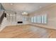 Elegant living room featuring hardwood floors, a fireplace, custom built-ins, and an ornate chandelier at 1169 Dorby Park Ne Dr, Brookhaven, GA 30319