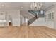 Open living area with hardwood floors, stairs, custom built-ins, connecting to the kitchen at 1169 Dorby Park Ne Dr, Brookhaven, GA 30319