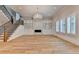 Bright living room showcases hardwood floors, fireplace, custom built-ins, and staircase at 1169 Dorby Park Ne Dr, Brookhaven, GA 30319