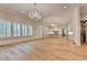 Living room with hardwood floors connects to a modern kitchen with an island and custom lighting at 1169 Dorby Park Ne Dr, Brookhaven, GA 30319