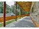 View of the brick home's open patio with stained wood supports and a stained fence at 1169 Dorby Park Ne Dr, Brookhaven, GA 30319