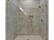 Shower showcases tile surround, a shower head, a built-in niche, and a glass door at 1169 Dorby Park Ne Dr, Brookhaven, GA 30319