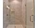 Luxurious tiled shower with a glass door, rainfall showerhead, and built-in niche at 1169 Dorby Park Ne Dr, Brookhaven, GA 30319