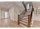 Open staircase featuring wood treads, black metal railing and wood banister at 1169 Dorby Park Ne Dr, Brookhaven, GA 30319