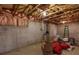 Unfinished basement shows concrete walls, wooden ceiling beams, and insulation, offering potential for customization at 203 Overlook Ct, Dallas, GA 30157