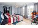 Cozy bedroom with a ceiling fan, large window, and a gaming chair at 203 Overlook Ct, Dallas, GA 30157