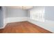 Spacious dining room featuring hardwood floors, wainscoting, and natural light from a large window at 203 Overlook Ct, Dallas, GA 30157