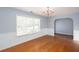 Inviting dining room with neutral walls, hardwood floors, and an arched doorway at 203 Overlook Ct, Dallas, GA 30157