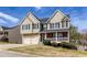Inviting home exterior showcasing a well-maintained lawn, mature shrubs, and a welcoming porch at 203 Overlook Ct, Dallas, GA 30157
