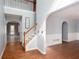 Welcoming foyer with hardwood floors, staircase, and arched doorways leading to other rooms at 203 Overlook Ct, Dallas, GA 30157