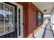 Cozy front porch showcasing brick accents, and a stylish front door with glass inserts at 203 Overlook Ct, Dallas, GA 30157
