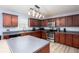 Kitchen features dark wood cabinets, stainless appliances and laminate floors at 203 Overlook Ct, Dallas, GA 30157