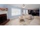Bright living room features a fireplace, ceiling fan, and large window with natural light at 203 Overlook Ct, Dallas, GA 30157
