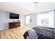 Bright primary bedroom with hardwood floors, tray ceilings, and windows for natural light at 203 Overlook Ct, Dallas, GA 30157