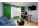 Comfortable office with a window for natural light, a modern desk, and a cozy blue couch at 203 Overlook Ct, Dallas, GA 30157