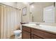Functional bathroom featuring a vanity, toilet, shower with curtain, and neutral walls, balancing simplicity and practicality at 364 Mossycup Dr, Fairburn, GA 30213