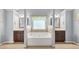 Bright bathroom featuring double vanities, a large soaking tub, and neutral wall colors for a serene spa-like experience at 364 Mossycup Dr, Fairburn, GA 30213