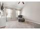 Airy bedroom with vaulted ceiling, plush carpeting, natural light, and chic seating, creating a cozy and inviting retreat at 364 Mossycup Dr, Fairburn, GA 30213