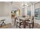 Elegant dining room featuring a modern chandelier, wainscoting, and an archway to the living room at 364 Mossycup Dr, Fairburn, GA 30213