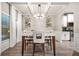 Stylish dining room featuring modern decor, lighting, and views into the kitchen area at 364 Mossycup Dr, Fairburn, GA 30213