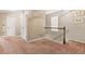 A carpeted hallway with a railing and a window at 364 Mossycup Dr, Fairburn, GA 30213