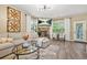 Comfortable living room featuring a stone fireplace, modern lighting, and stylish decor at 364 Mossycup Dr, Fairburn, GA 30213
