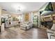 Spacious living room with a fireplace, sectional sofa, and archway to the foyer at 364 Mossycup Dr, Fairburn, GA 30213