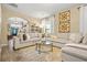 Bright living room showcasing a large sectional sofa, modern table, and arched doorway at 364 Mossycup Dr, Fairburn, GA 30213
